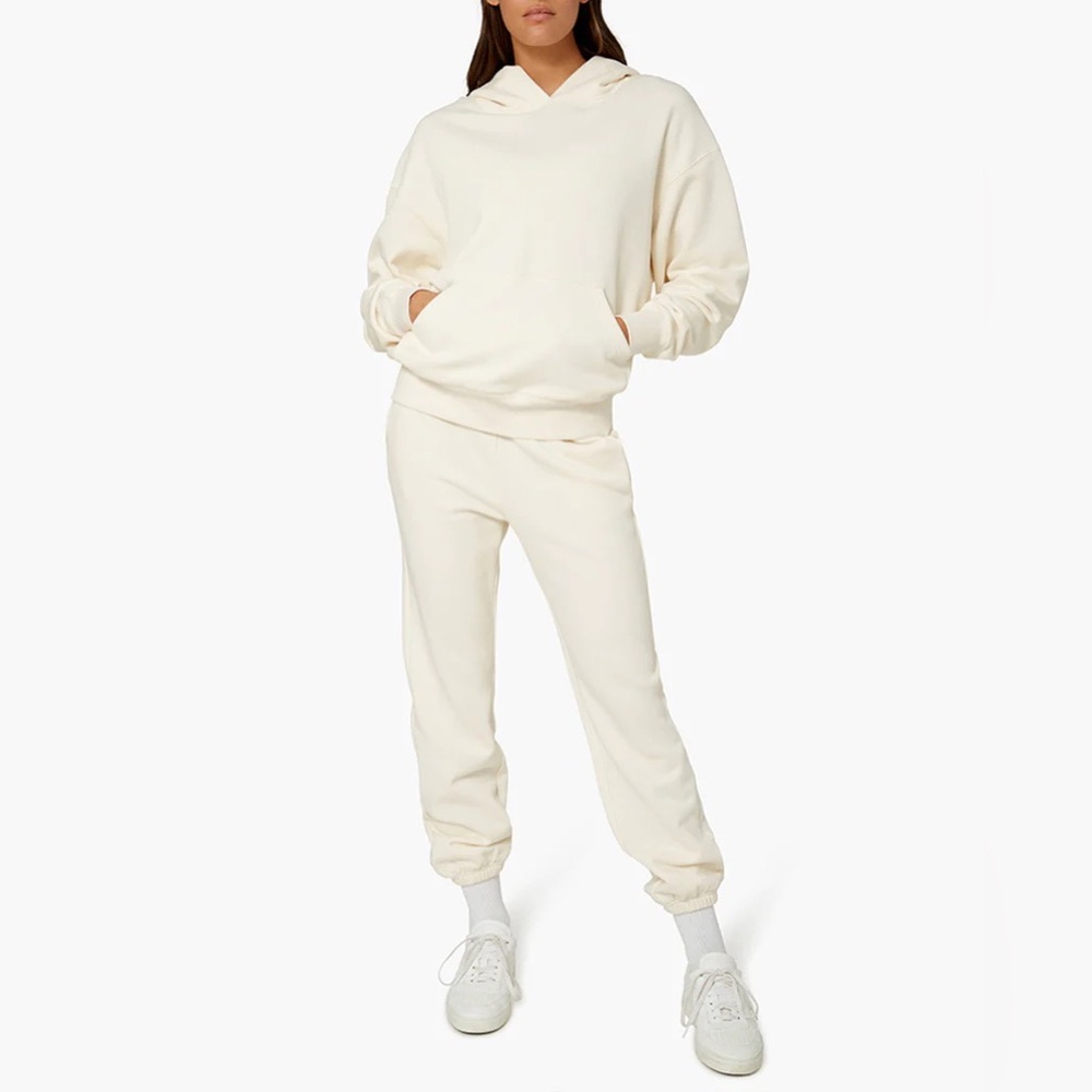 Weworewhat matching hoodie and jogger sweatpants set in color ivory.